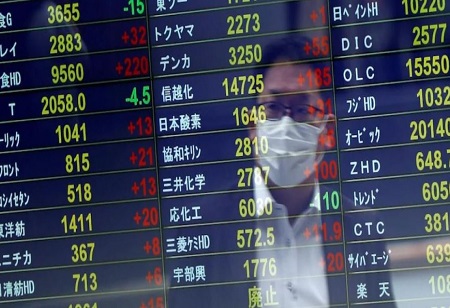 Asian stocks rise, while the dollar falls as markets assess Fed risks